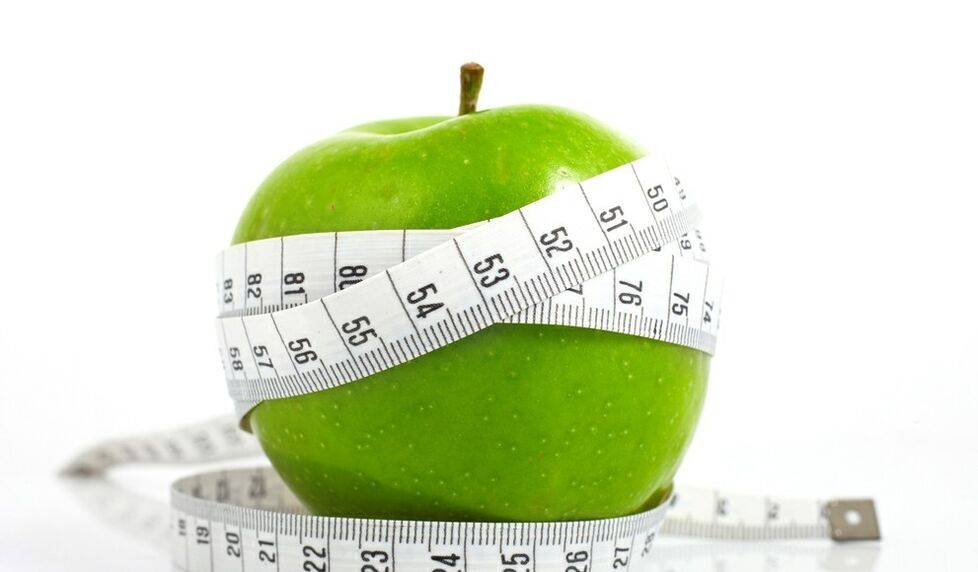 Pomme enveloppée d'un ruban à mesurer